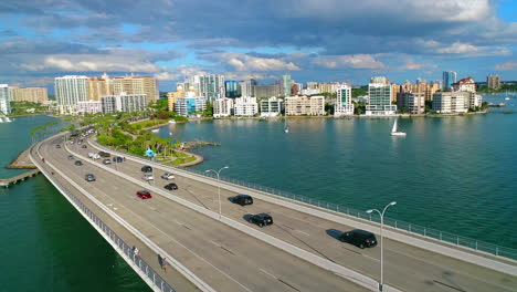 Aerial-flight-over-traffic-on-John-Ringling-Bridge-going-into-Downtown-Sarasota-in-Florida
