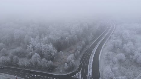 Highway-Road-in-Snowy-Winter-Landscape-of-Nordic-Countryside---Aerial