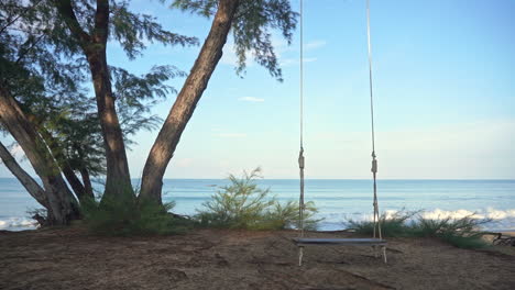 Empty-swing-with-blue-sea-in-background.-Slow-motion