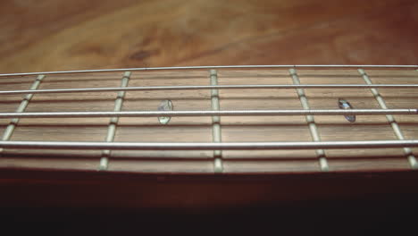 Gentle-slider-along-bass-guitar-strings-following-neck