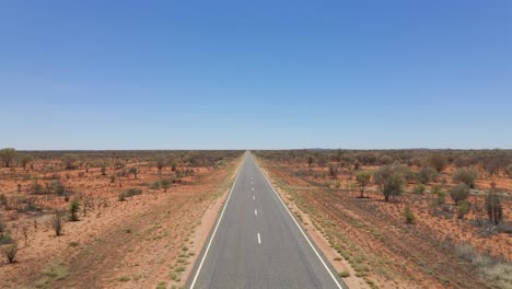 Caucasian-Woman-Walking-On-Long-And-Winding-Uluru-Road