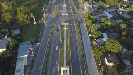 Aerial-View-of-Suburban-Road-Traffic-on-Sunny-Morning,-San-Jose-Del-Ricon,-Santa-Fe,-Argentina,-Tilt-Up-Drone-Shot