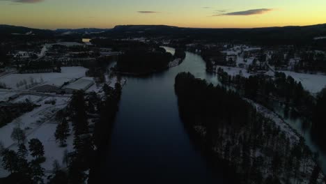 Yellow-Sky-Over-River-Surrounded-by-Forest,-Forward-Aerial