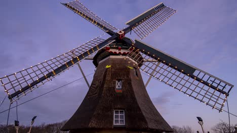 Day-to-night-time-lapse-of-smock-mill-in-foreground-with-clouds-moving-in-background
