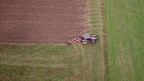 Wide-aerial-shot-of-a-tractor-plowing-fields