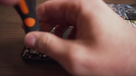 Man-Unscrews-and-Removes-Hard-Drive-from-Laptop-using-Hands-and-Screwdriver