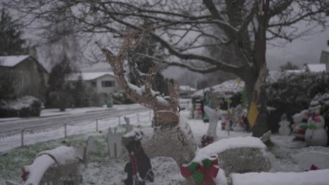 Close-up-footage-of-a-reindeer-Christmas-lawn-ornament-in-a-snowy-residential-neighborhood