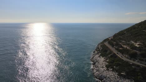 Aerial-views-of-the-coast-cliffs-nearby-Barcelona-with-the-sunshine-on-the-sea
