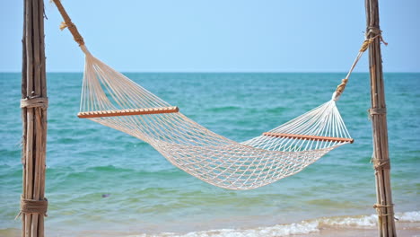 An-empty-hammock-with-the-ocean-in-the-background