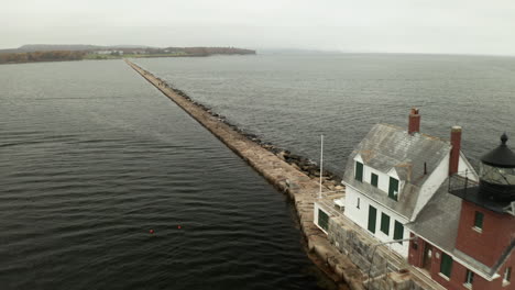 Aerial-Fly-By-Drone-footage-of-lighthouse-on-the-breakwater-at-Rockland,-Maine,-USA