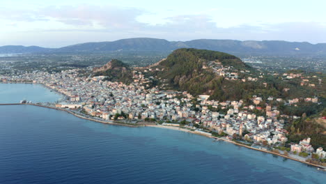 Drone-aerial-shot-of-Zante-town-holiday-spot-overlooking-town-and-port,-Zakynthos,-Greece