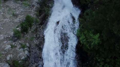 Overhead-Flug-über-Einen-Wasserfall-Mit-Tosendem-Wildwasser,-Das-Während-Des-Frühlingsabflusses-über-Die-Felsen-Rauscht