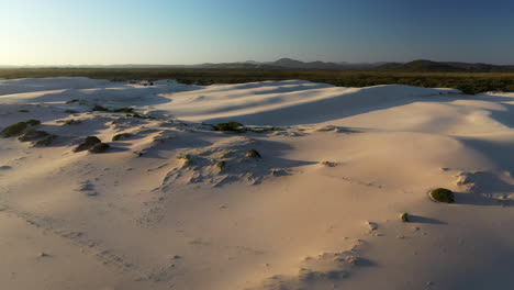 Cinematic-wide-drone-shot-of-the-Dark-Point-sand-dunes-at-Hawks-Nest,-New-South-Wales,-Australia