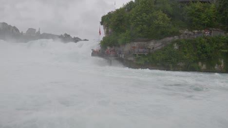 View-platform-for-tourist-next-to-Rhine-Falls,-Switzerland-view-from-boat
