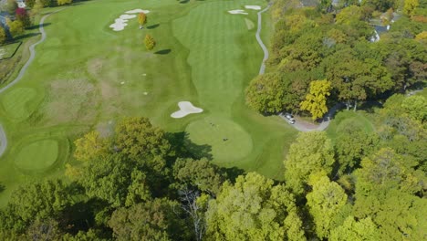 Top-Down-Aerial-View-of-Golf-Players-Teeing-Off-at-Golf-Club