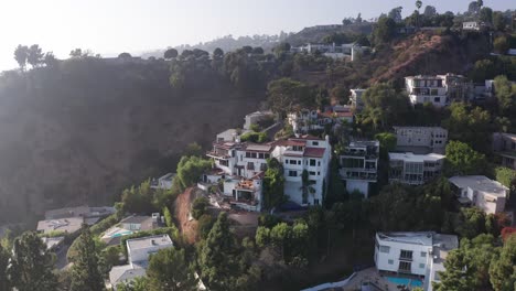 Aerial-rising-shot-tilting-down-on-mansions-dotting-the-hillside-in-Beverly-Hills