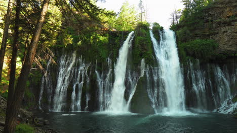 Landscape-view-of-Burney-Falls,-forest-waterfall-in-California,-with-water-falling-down-a-cliff