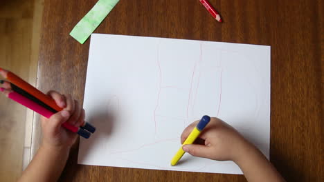 Child-is-drawing-doodle-with-crayons,-toddler-learn-and-play