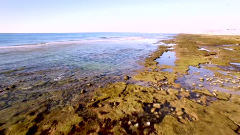 Aerial-high-angle-flyover-the-tide-pools-and-intertidal-beaches-,-Rocky-Point,-Mexico