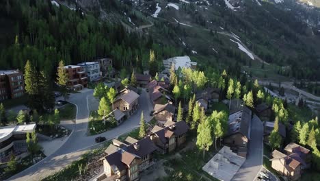 A-drone-flight-over-a-small-village-like-ski-resort-in-the-mountains-of-Utah-as-the-sun-rises-in-spring