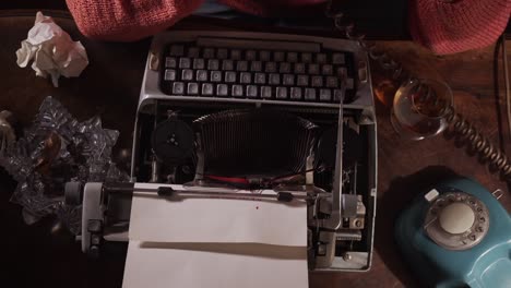 Author-writes-with-typewriter-at-desk-with-rotary-phone-and-cigar,-overhead
