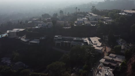 Tilting-up-aerial-shot-of-Beverly-Hills-with-smoky-haze-in-the-sky