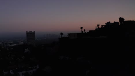Descending-aerial-shot-of-Century-City-skyline-during-twilight-with-smoky-hazy-air
