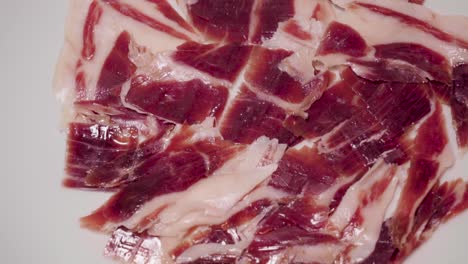 Panning-Right-Above-Sliced-Jamon-Iberico,-Popular-Spanish-Delicacy