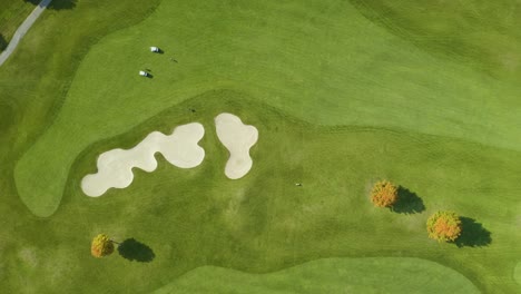 Top-Down-Aerial-View-of-Golf-Course-with-Sand-Trap-in-Fall