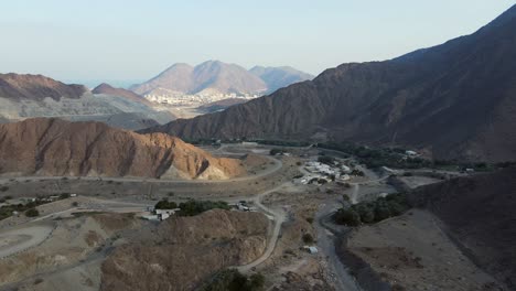 UAE-MOUNTAINS:-Top-View-of-Khorfakkan-village-and-mountains,-a-traditional-northern-town-between-the-hills