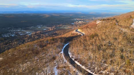 A-scenic,-winding-mountain-road-during-winter-with-light-snow-in-the-Appalachian-mountains