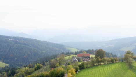 Forest,-rural-farmland-and-houses-in-Prevalje,-Slovenia