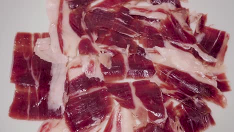 Rotating-Jamon-Iberico,-Spanish-Cured-Ham,-on-Isolated-White-Background