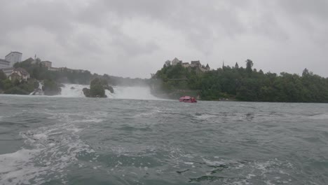 Rhine-Falls-waterfall-panorama,-swift-rushing-river-water-in-rain,-Switzerland