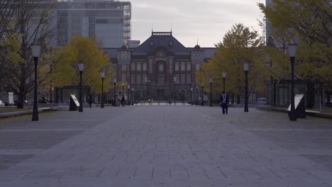 Slow-tilt-up-towards-Tokyo-Station-with-few-people-during-early-morning