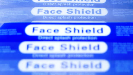 Panning-shot-of-stack-of-face-shield