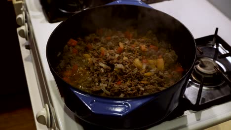 Ground-beef,-onions,-and-bell-peppers-simmering-in-Dutch-oven-on-gas-stove