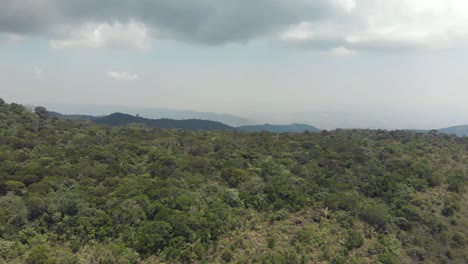 Lush-green-south-easterner-landscape-of-Bokor-Mountains-in-Kampot,-Cambodia---Aerial-Panoramic-shot