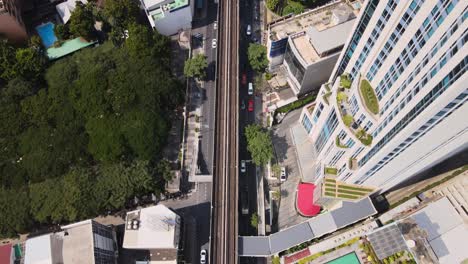 4k-Tilt-UP-Aerial-Cinematic-shot-above-BTS-Railway-among-skyscrapers-in-Bangkok-City