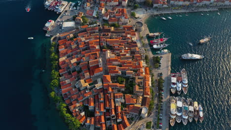 Beautiful-Korčula-old-town-and-harbour,-Croatian-island-landscape,-aerial-reveal