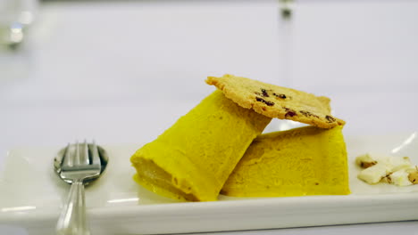 Gourmet-reinterpretation-of-Indian-Kulfi-dish-with-mango,-pistachio-and-nougat-crumble