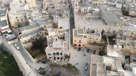 Mdina-city-walls-and-old-cityscape,-near-the-Cathedral-of-Saint-Paul---Aerial-Fly-over-slow-tilt-up-shot