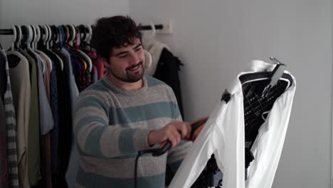 Young-man-ironing-his-shirt-at-home