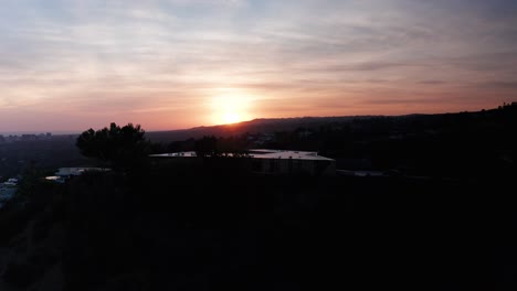 Rising-aerial-shot-of-Beverly-Hills-hillside-during-sunset