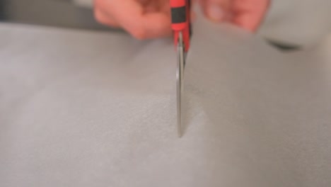Slow-motion-cutting-baking-paper-towards-the-camera