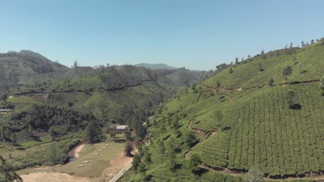 Panning,-4k-aerial,-drone-footage-of-the-a-vast-valley-of-the-Western-Ghats-mountain-range-near-the-countryside-tea-plantation-town-of-Munnar,-India