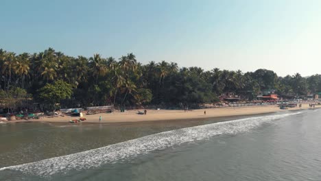 4k-aerial-drone-footage-of-a-beautiful-tropic-beach-with-a-few-visitors-at-the-tourist-destination-spot-of-Palolem,-India
