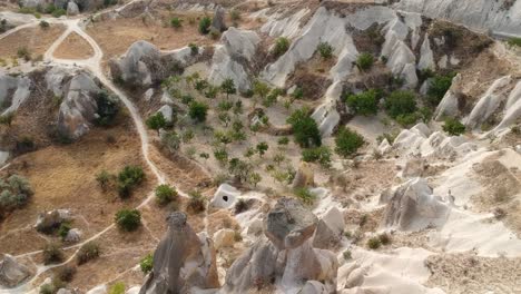 Cappadocia-bizarre-volcanic-chimneys-rock-formation-landmark-geological-Turkish-aerial-slow-fly-over