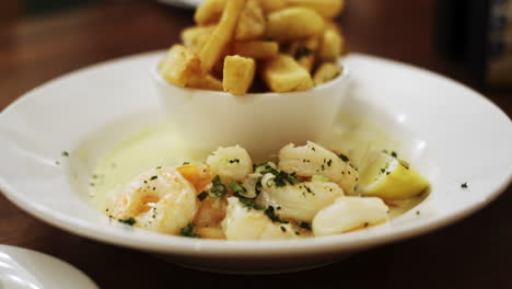Dolly-forward-of-Shrimp-in-cream-sauce-and-French-fries-dish