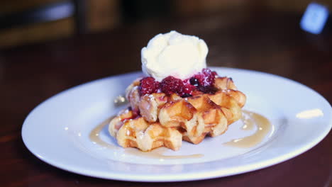 Delicious-Waffle-with-maple-syrup,-thickened-cream-and-berry-compote